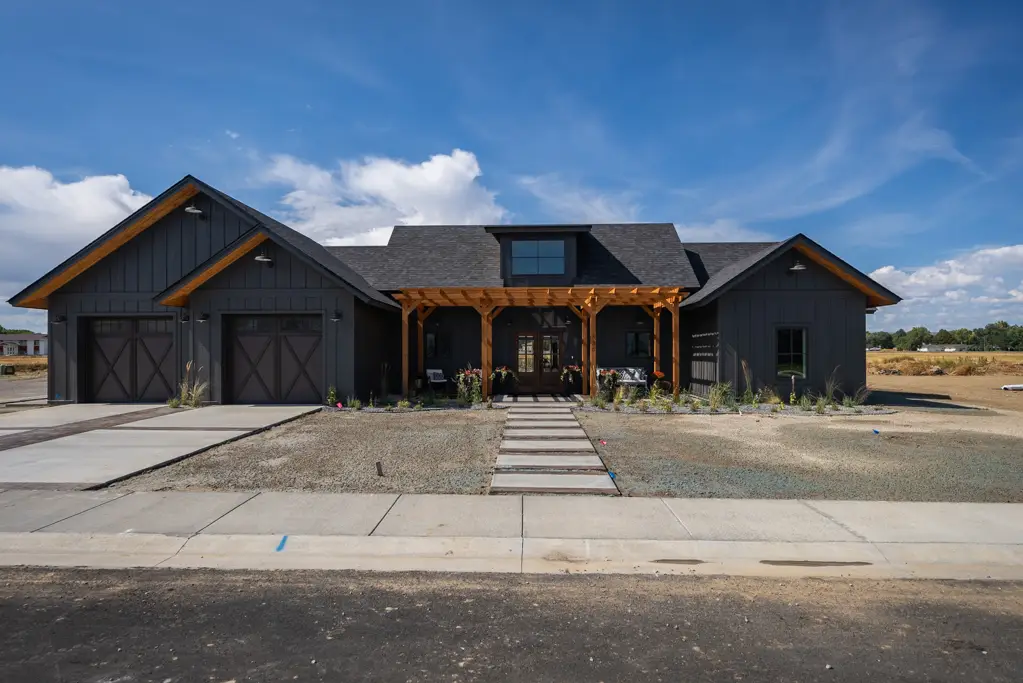 Exterior photo of a one-story modern black home built by Harvell Homes in Powell, Wyoming