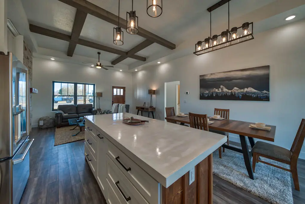 Interior photo of open-floor kitchen, dining, and living room in Powell, Wyoming built and designed by Harvell Homes