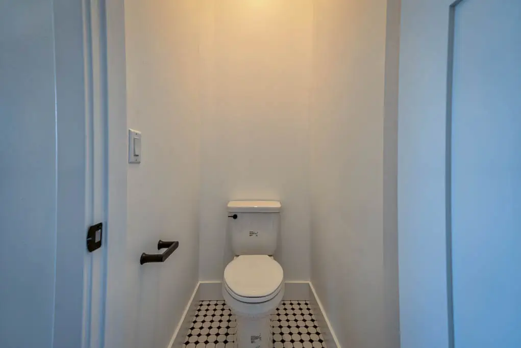 Interior photo of a home built by Harvell Homes in Powell, Wyoming featuring a modern farmhouse water closet with tile flooring