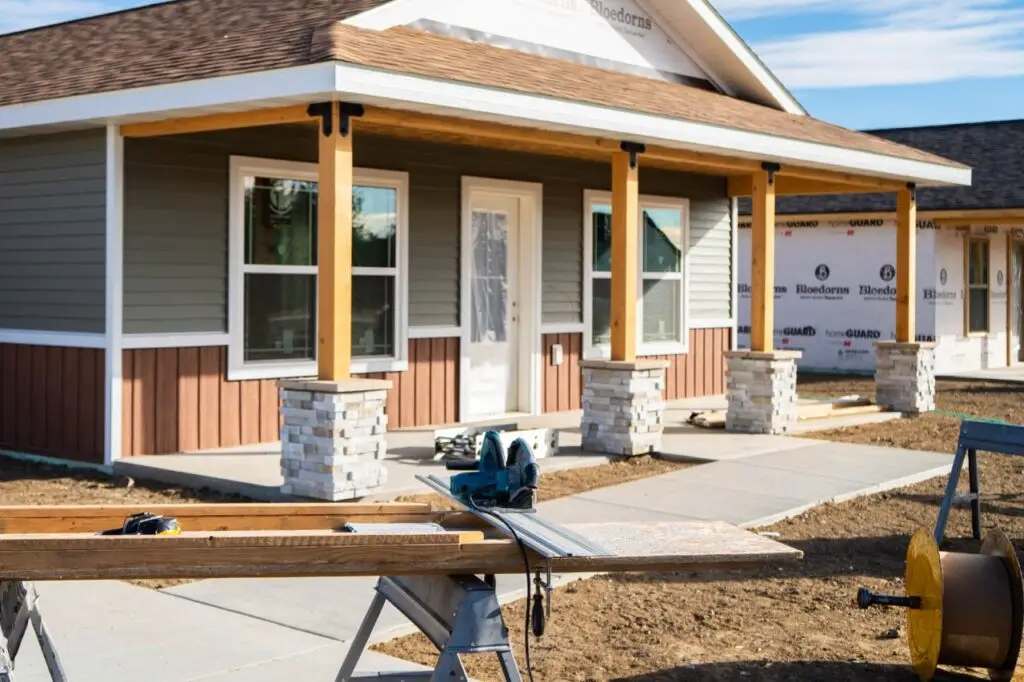 Homeowner reviewing finances and mortgage documents while planning the purchase of a new custom home.