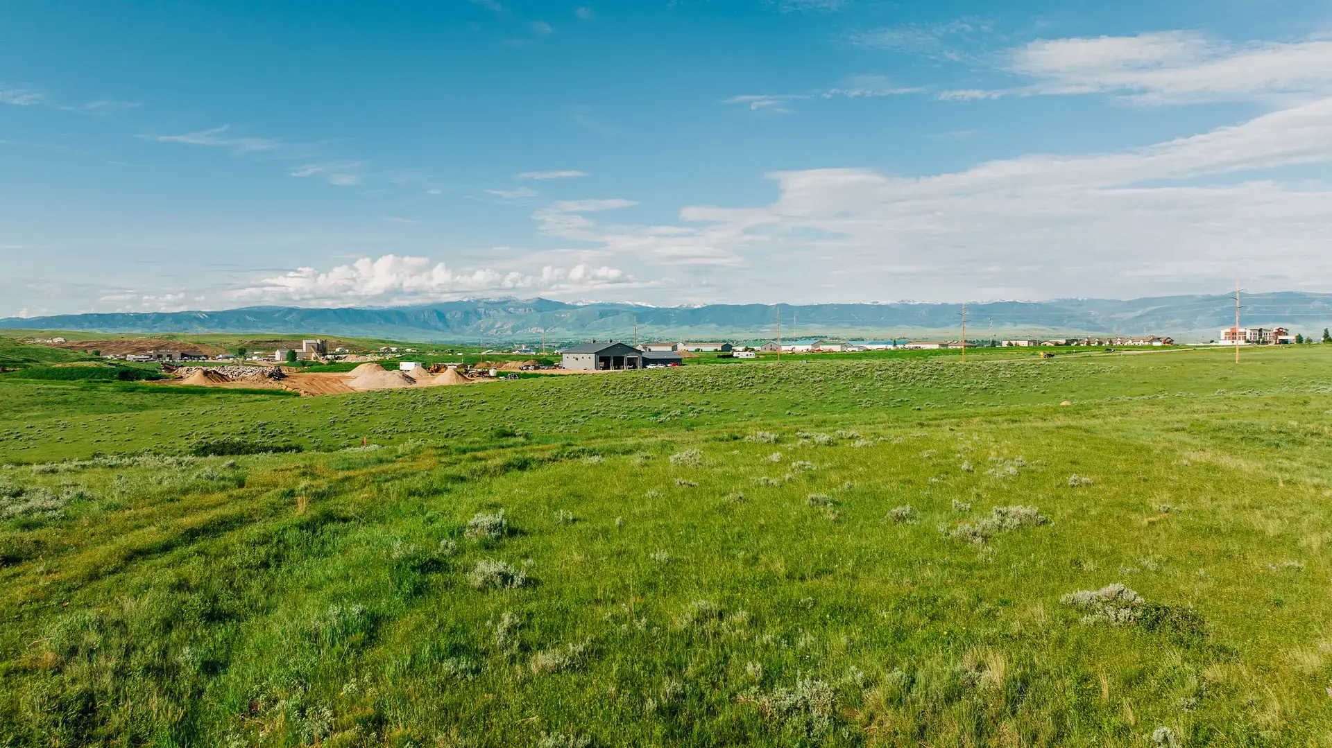 Open green space surrounding Story House Village with mountain views in Sheridan, Wyoming.